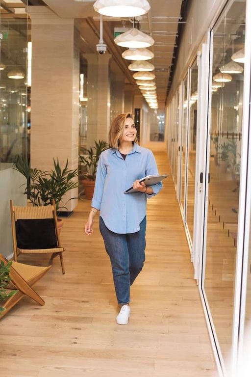 Smiling woman walking through a hallway