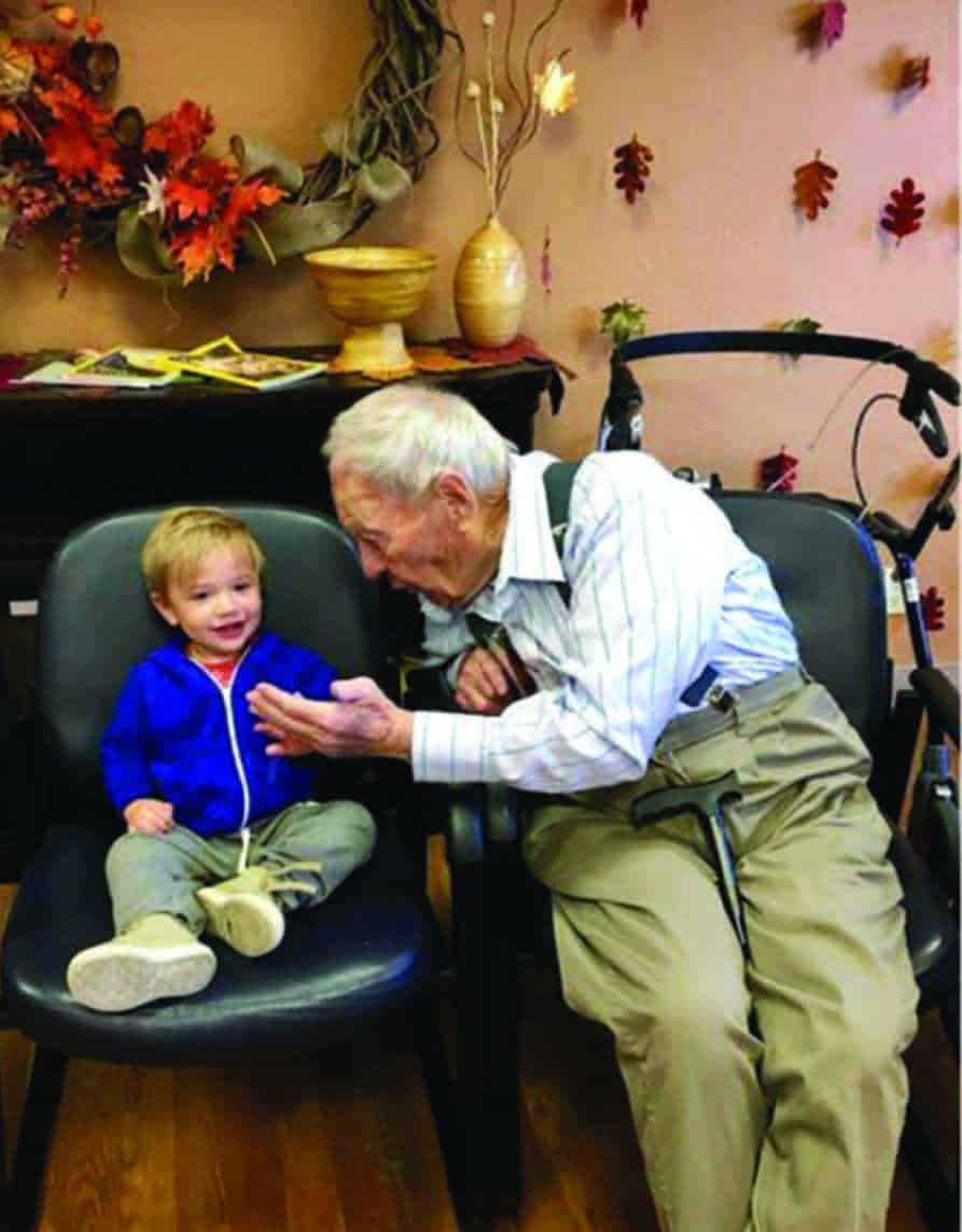 Elderly man talking to a toddler